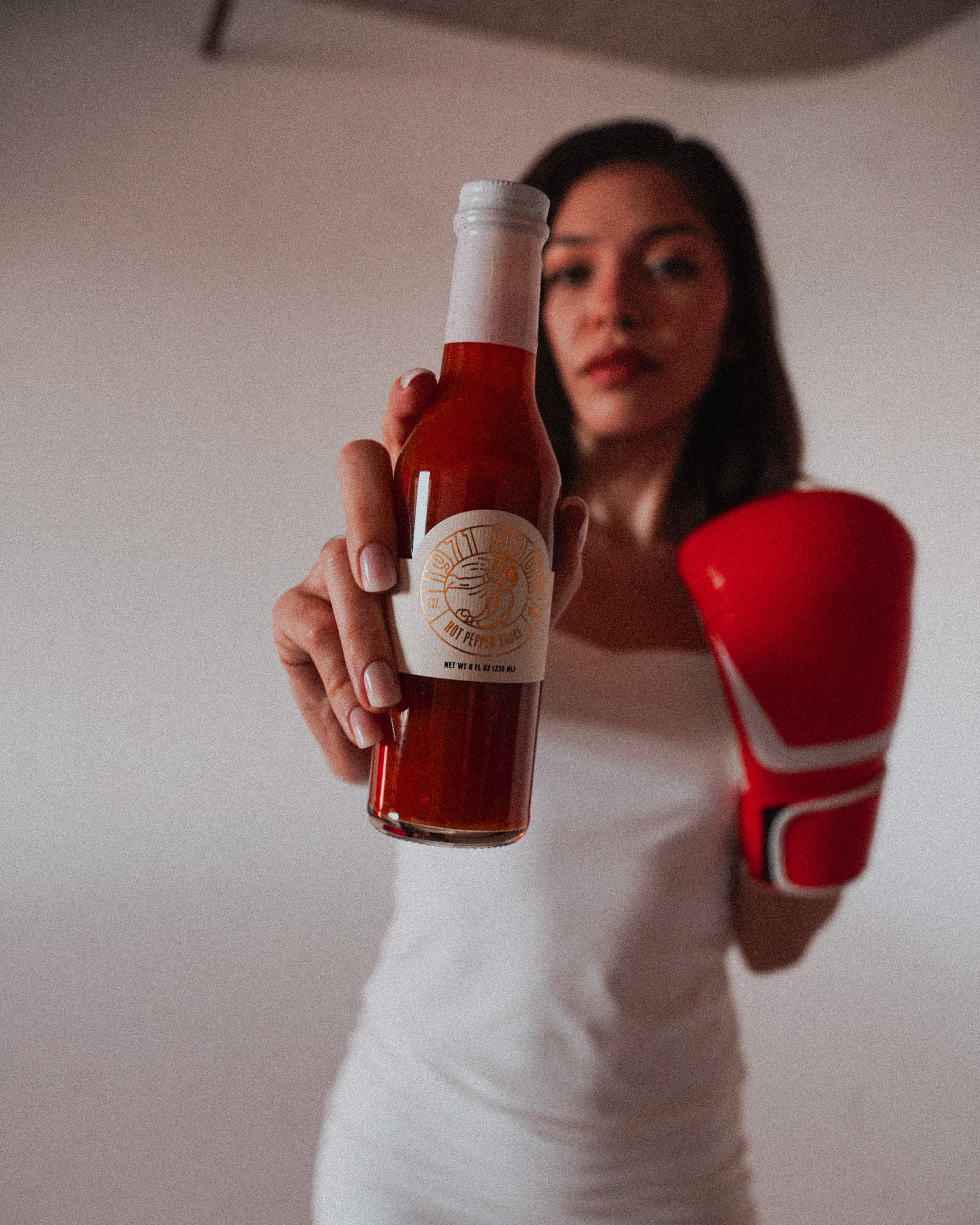 Alyssa holding the 1971 Hook bottle out toward the camera