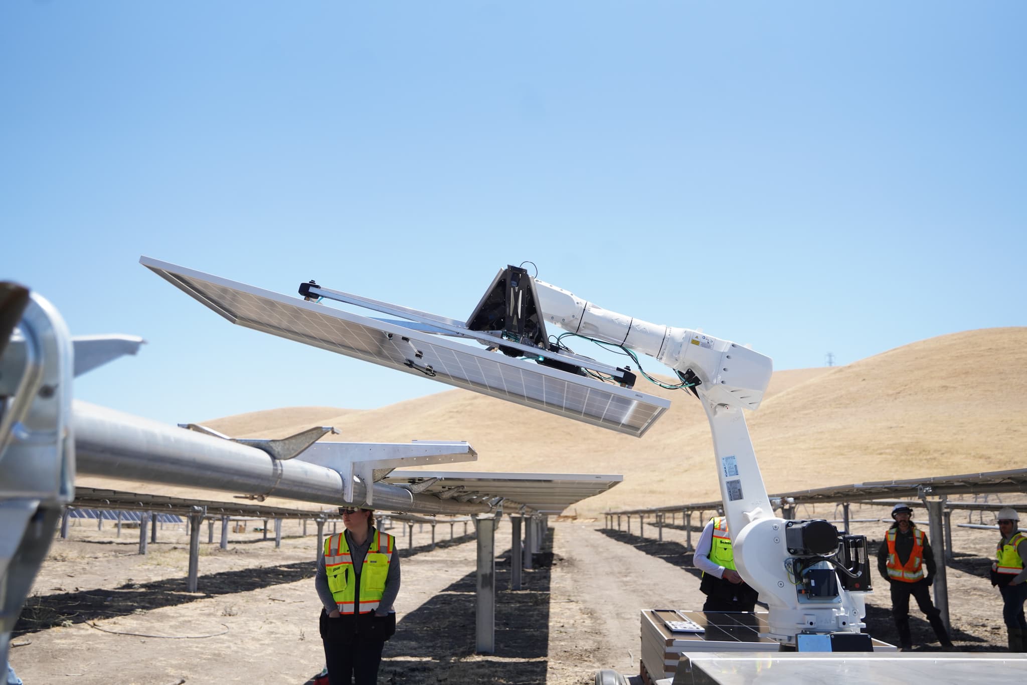 Arm lifting a panel with the California hills behind, Patterson