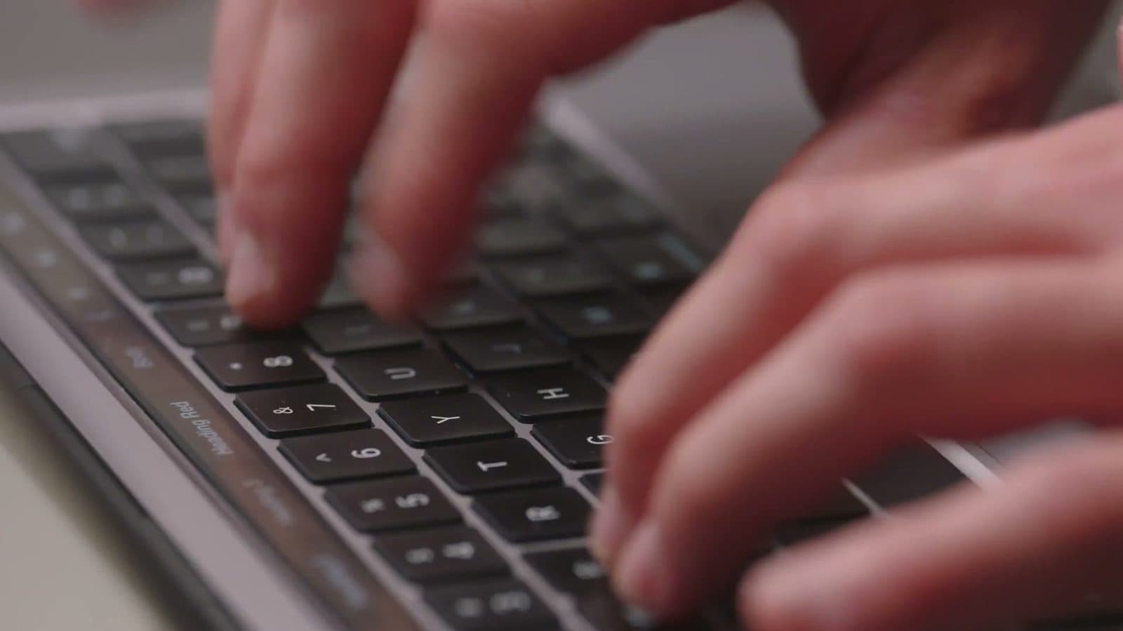 Hände auf einer Laptop-Tastatur