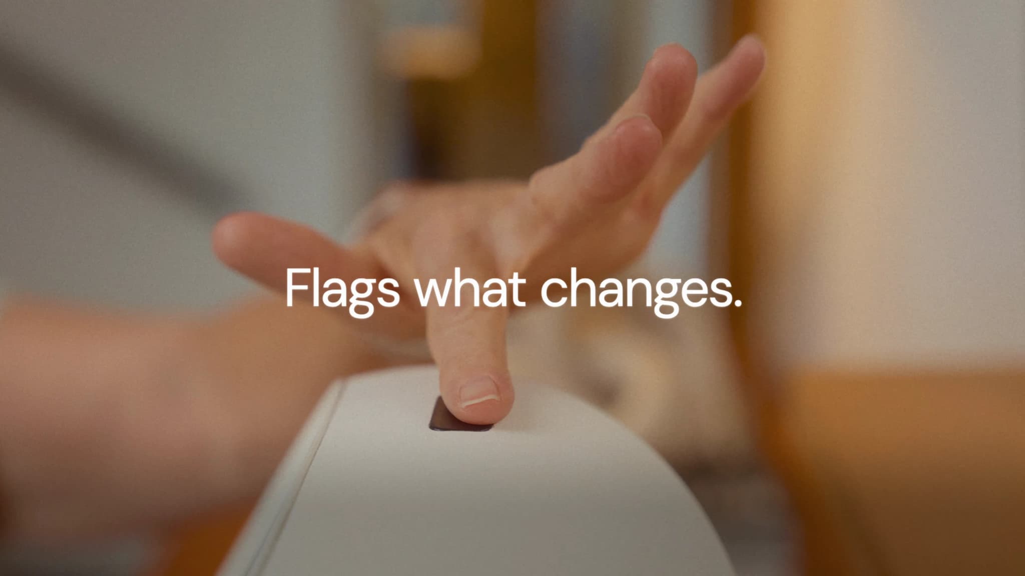 Close-up of Donna using Rhem’s health sensor with the title Flags what changes