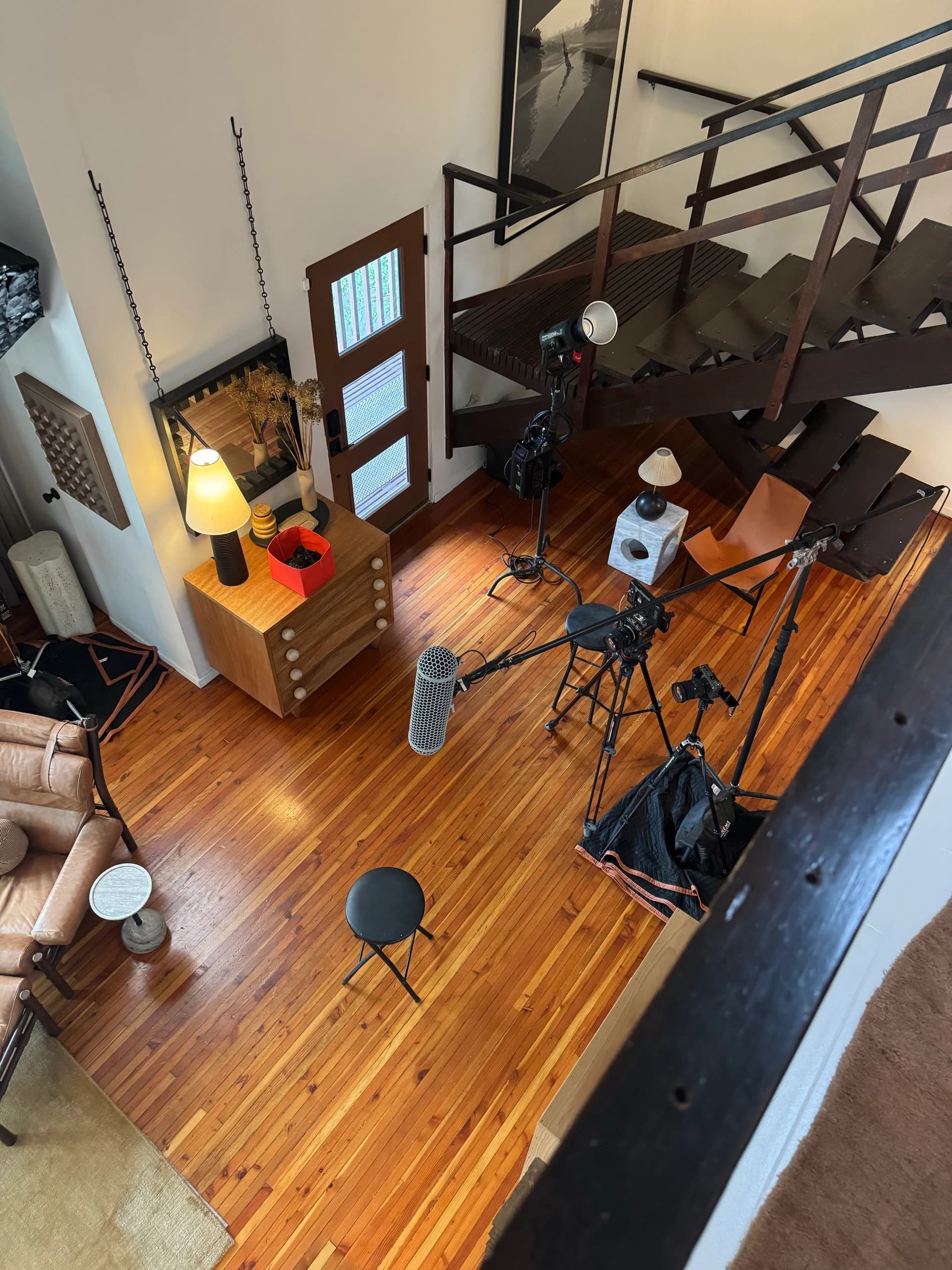 Cameras, boom microphone and lighting seen from the staircase