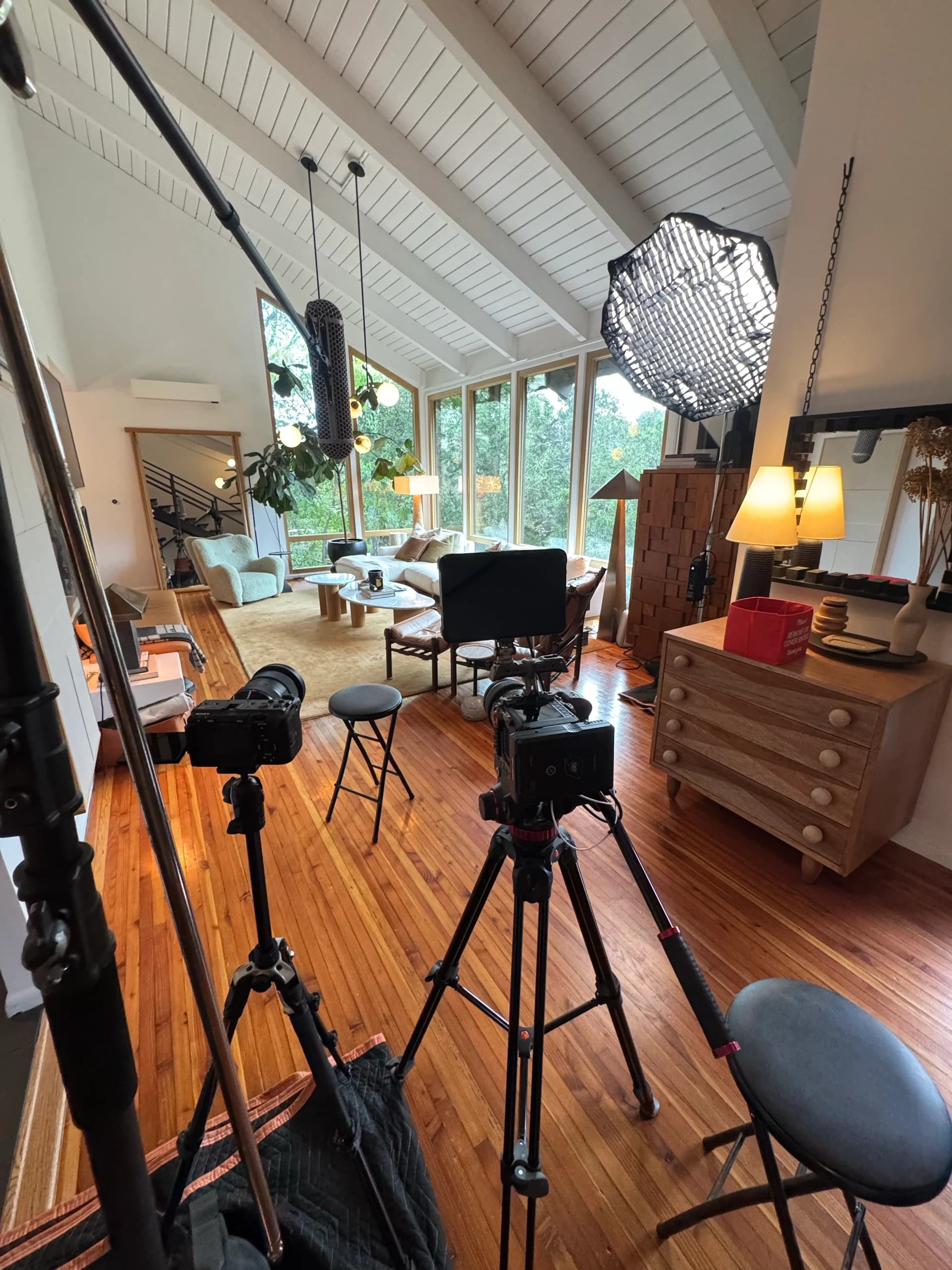 Two-camera interview setup with a boom microphone and softbox in the living room